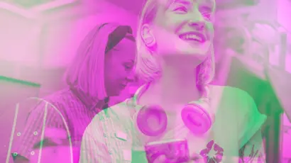 Woman stands indoors smiling while holding a mobile phone, with headphones resting around her neck. The same woman appears again in a layered view standing slightly behind and looking downward.